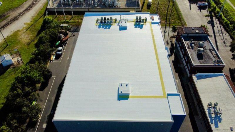 Reflective white GacoFlex cool-roof overlay on a commercial building