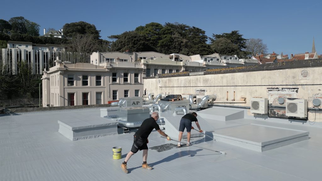 Torquay, England: GacoFlex S42 silicone being roller-applied to a flat roof (UK project).