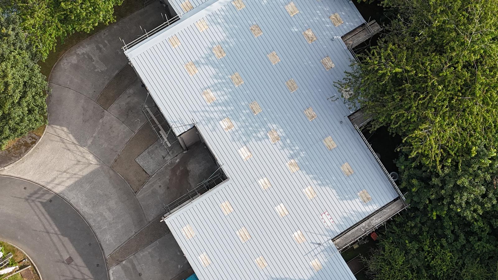 Commercial industrial roof sealed with GacoFlex silicone after leak repair