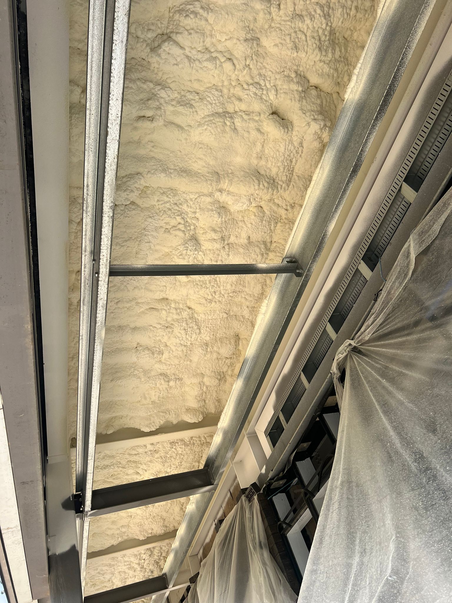 Warehouse soffit insulation with hybrid Nexseal and Sucraseal system
