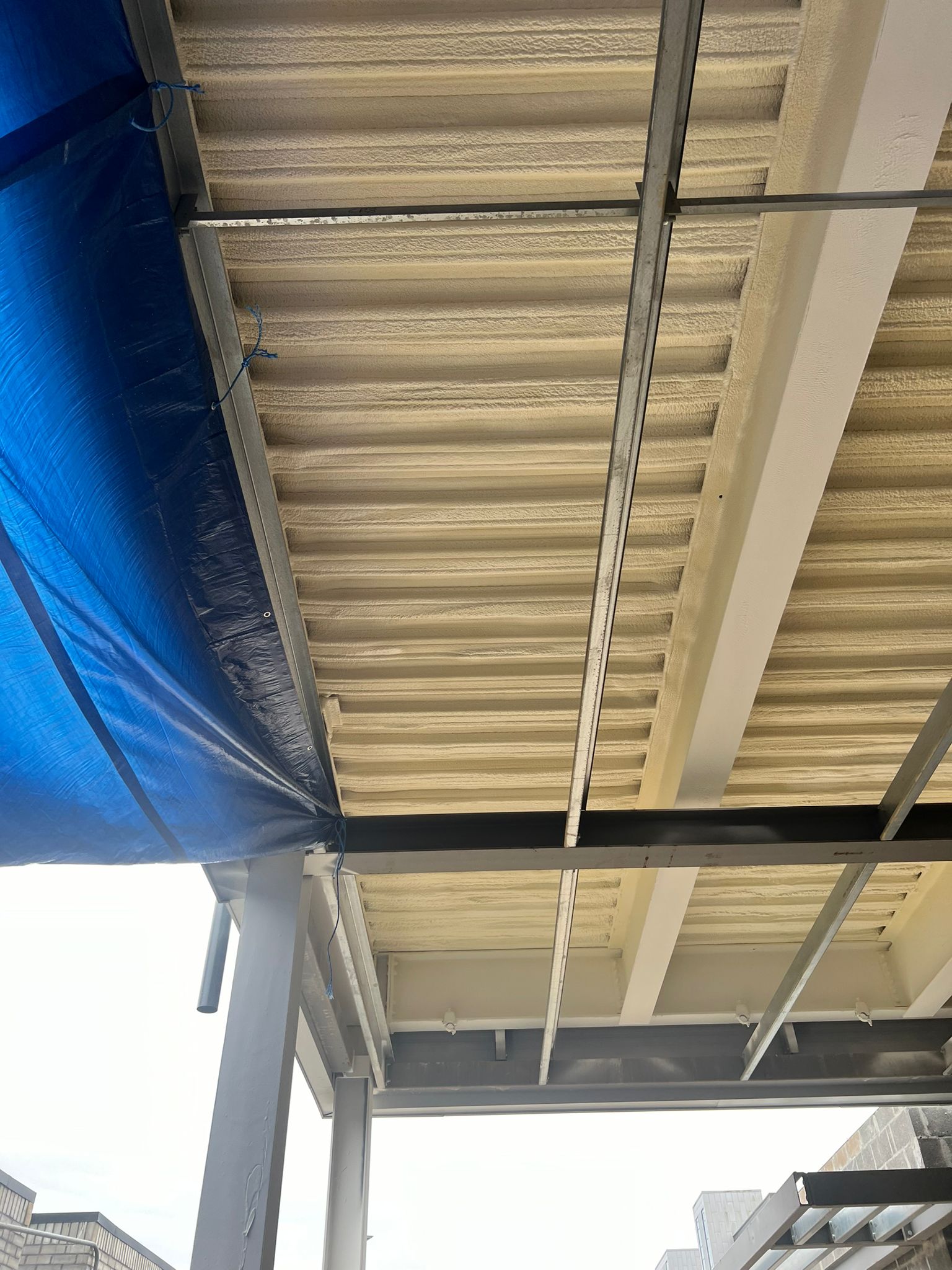 Nexseal LE closed-cell spray foam applied to Metsec metal deck car park soffit