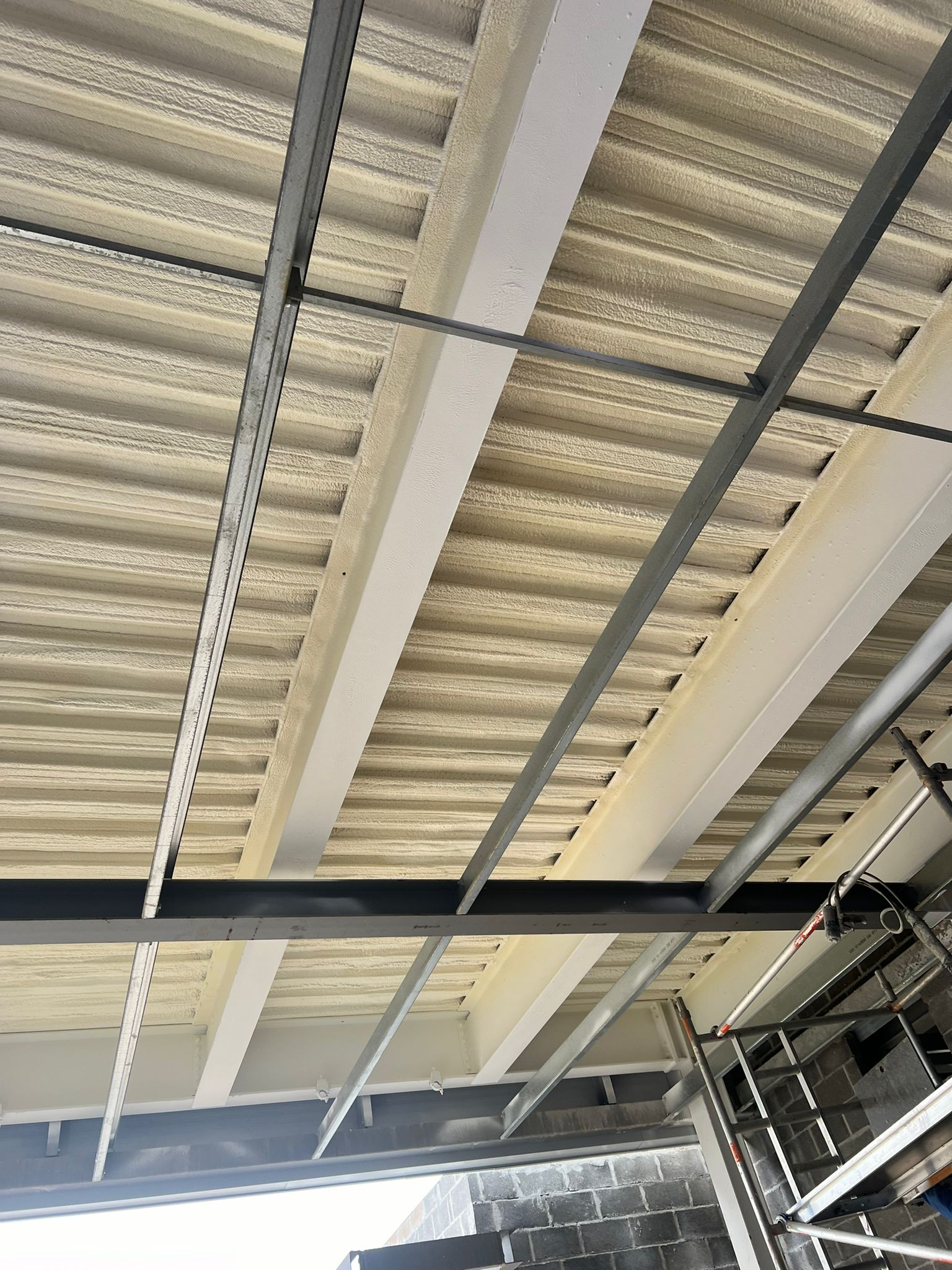 Nexseal LE closed-cell foam applied to metal deck car park soffit trough profile
