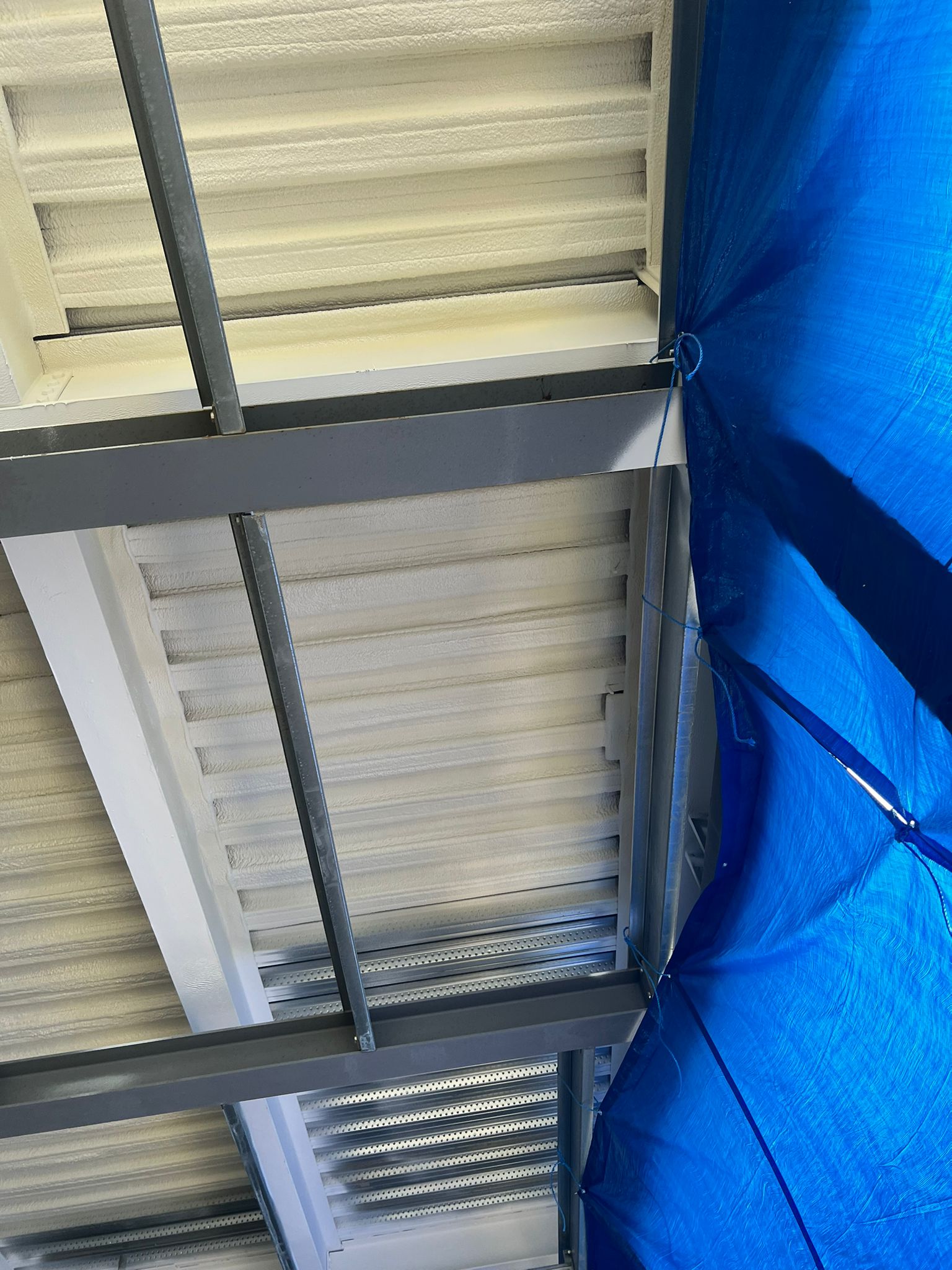 School building soffit with DC315 intumescent fire-rated topcoat