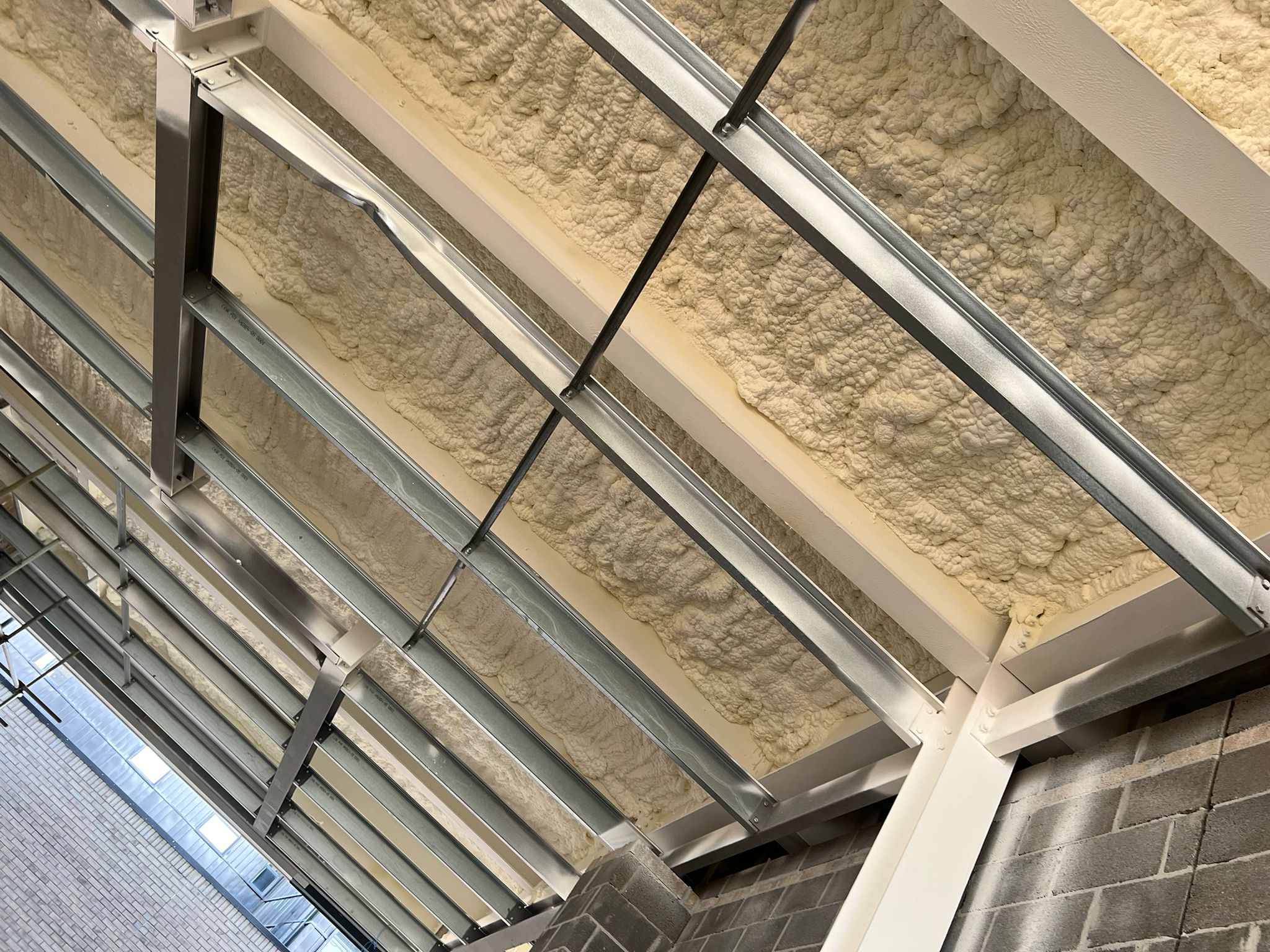 Mixed-use commercial residential building soffit insulation retrofit