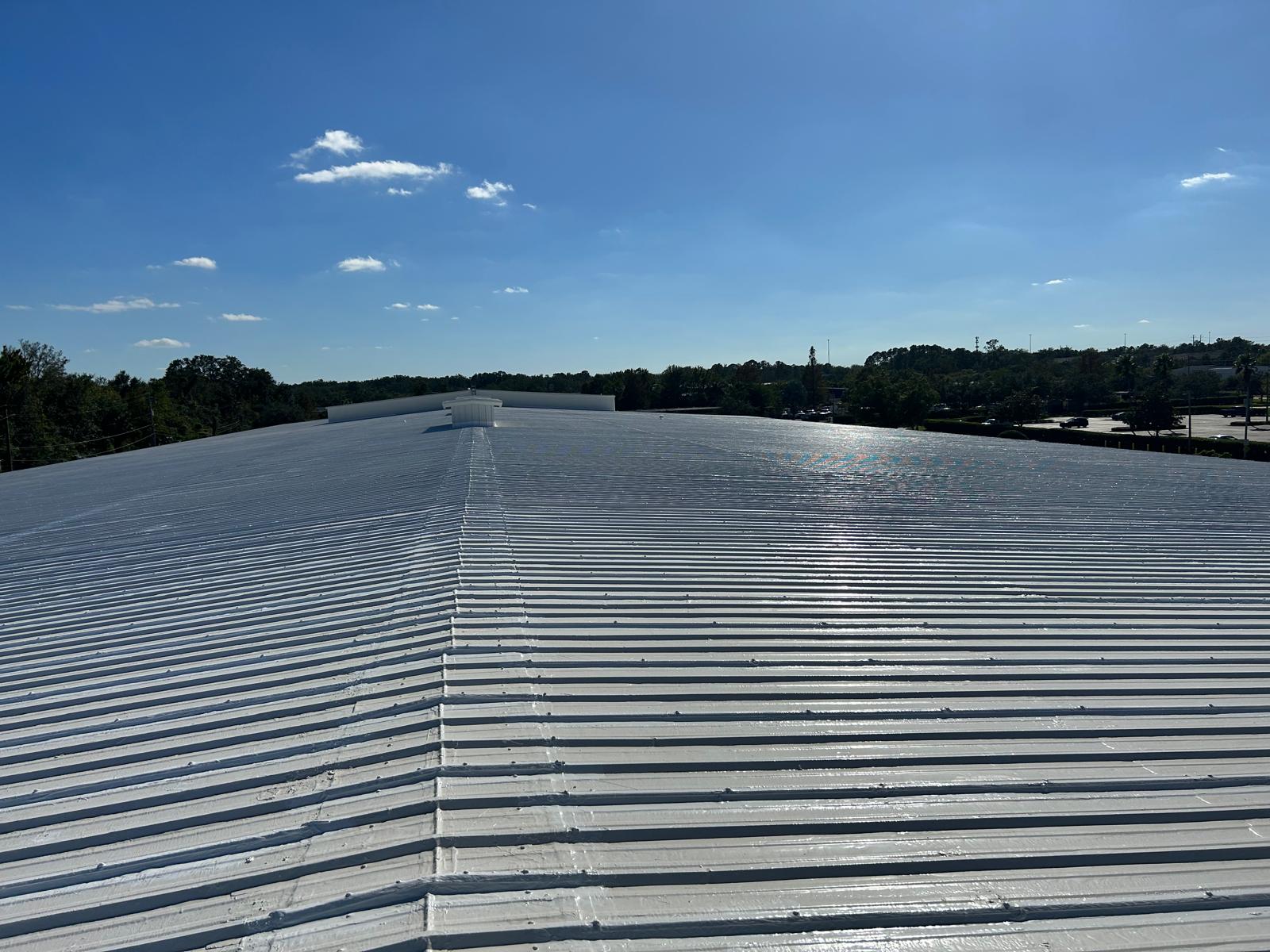Seamless GacoFlex silicone membrane being applied to a commercial roof