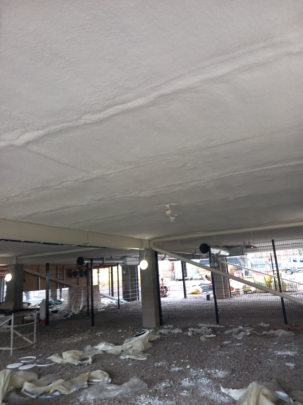 Warehouse metal deck soffit insulation with hybrid Nexseal Sucraseal system