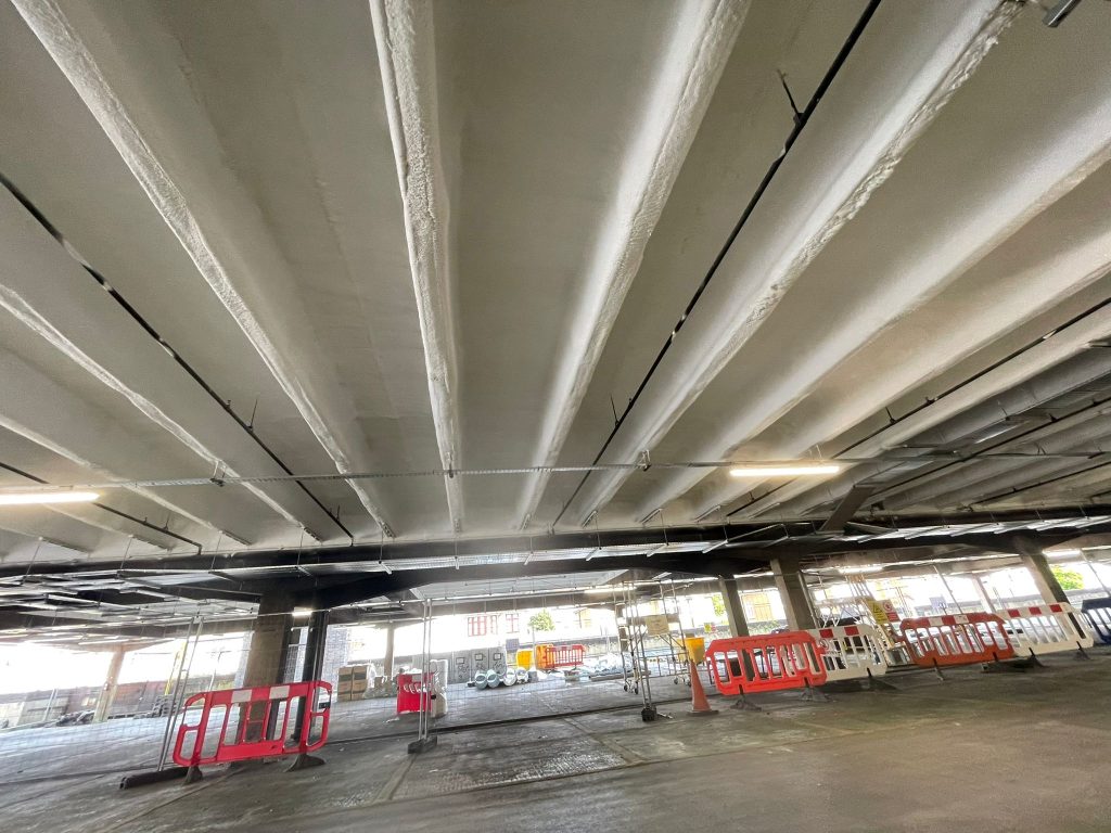 Spray foam applied across the soffit of a large open undercroft deck.