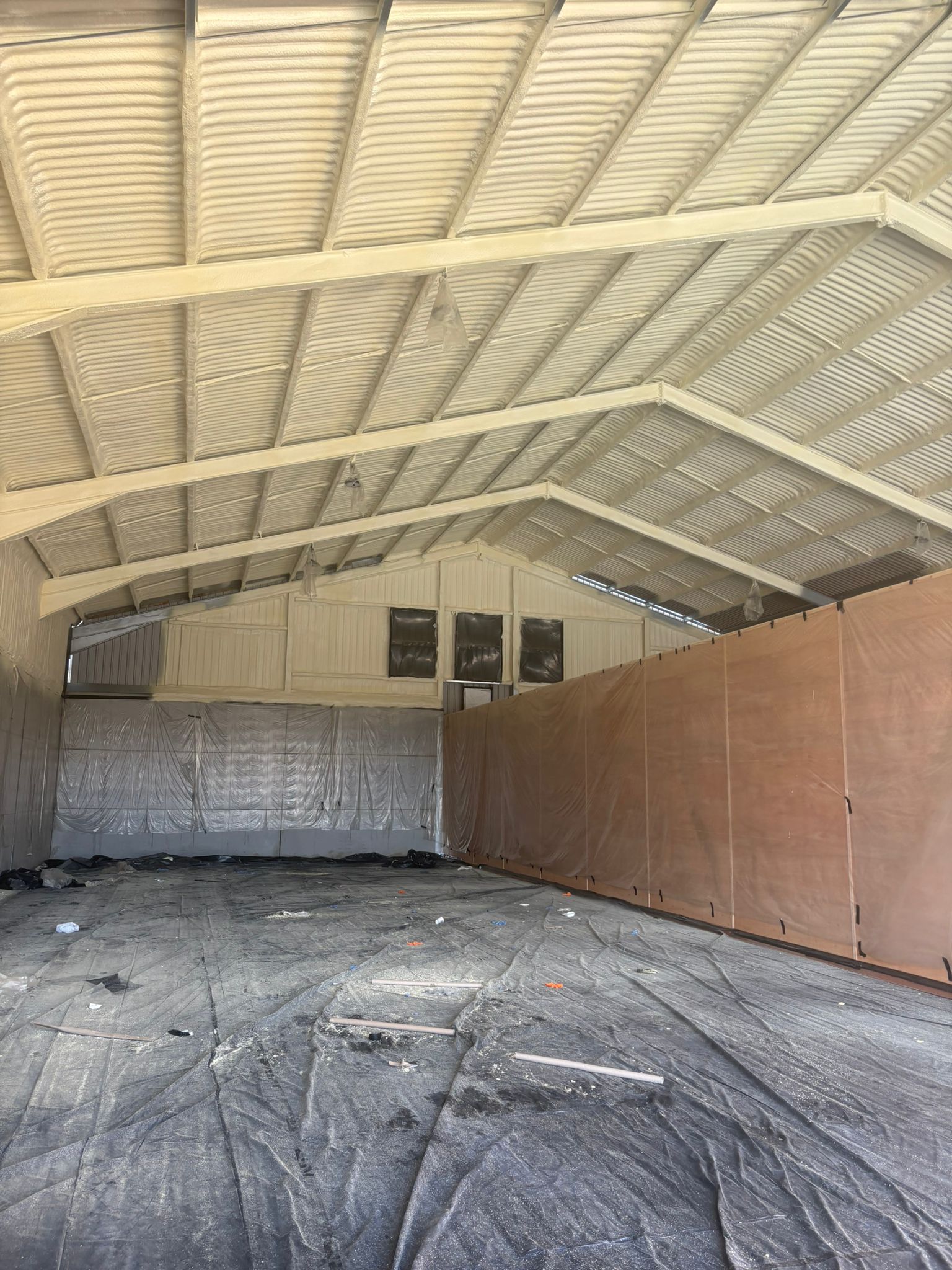 Nexseal LE closed-cell spray foam sealed across the underside of asbestos cement roof sheets