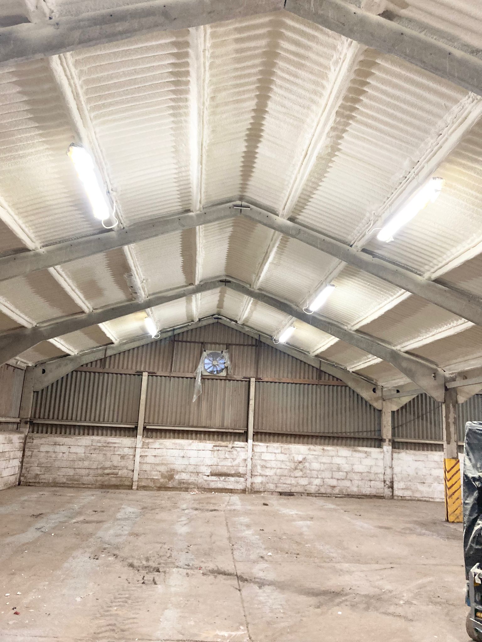 Completed asbestos roof encapsulation seen from inside the unit