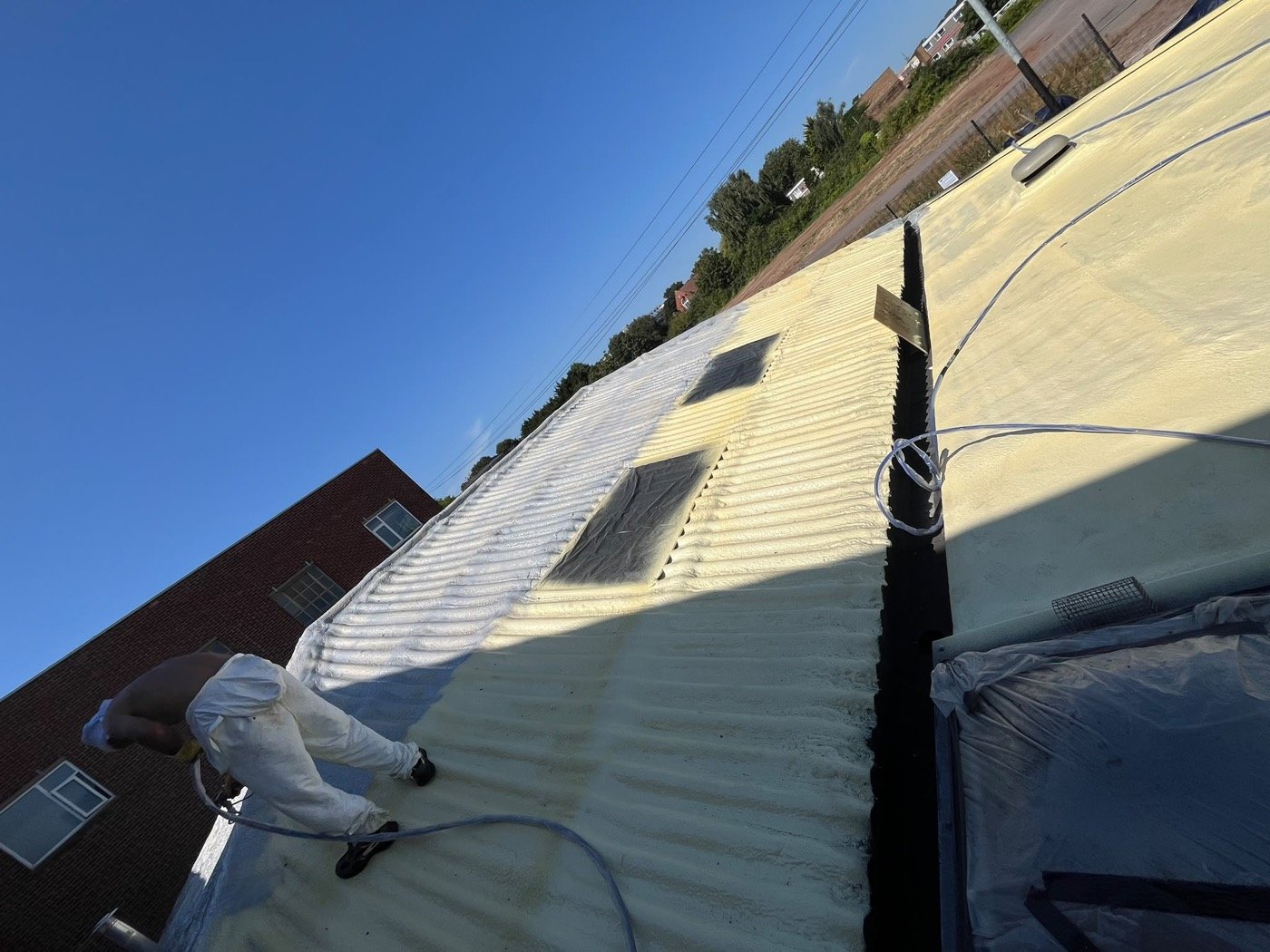 Purios HR closed-cell roofing foam applied across a pitched and flat roof