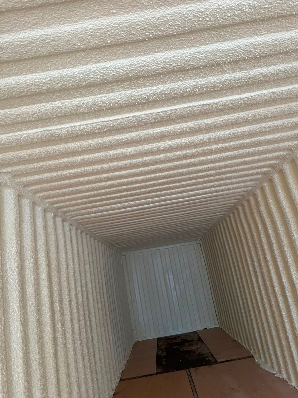 Shipping container interior fully insulated with closed-cell spray foam
