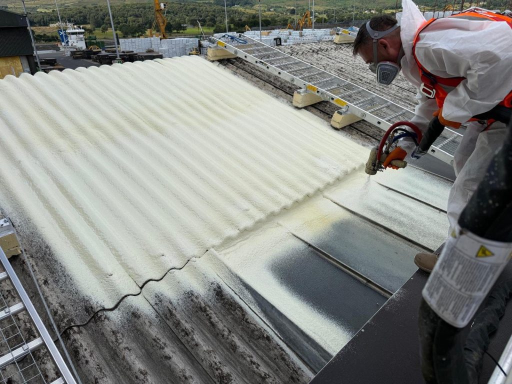 SAICA, Warrenpoint, County Down: closed-cell roofing foam spray-applied from the walkway system over asbestos cement (Northern Ireland project).