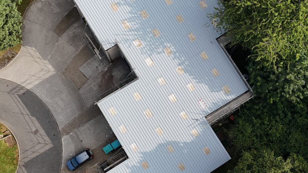 Falmouth, England: the same Gaco silicone system across five units at Tresidder Close, from the air (UK project).
