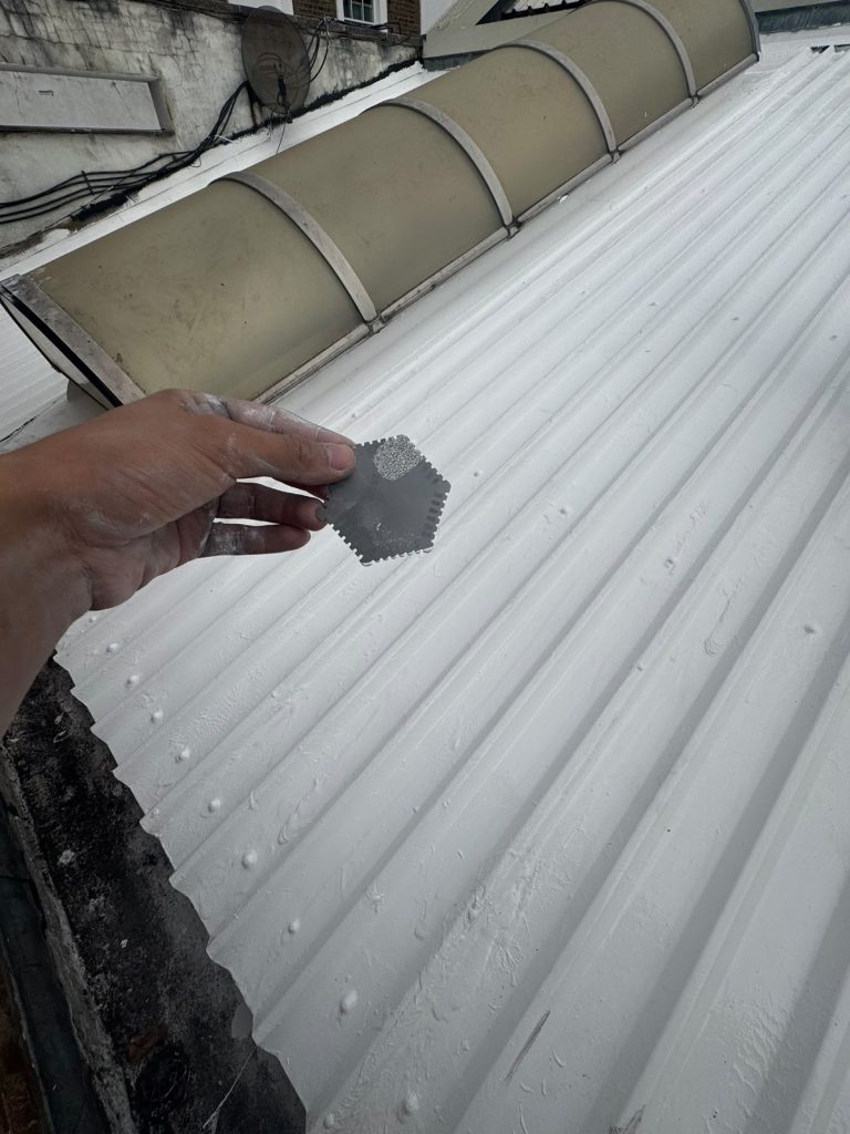 Film thickness checked with a comb gauge on the finished white silicone coat.